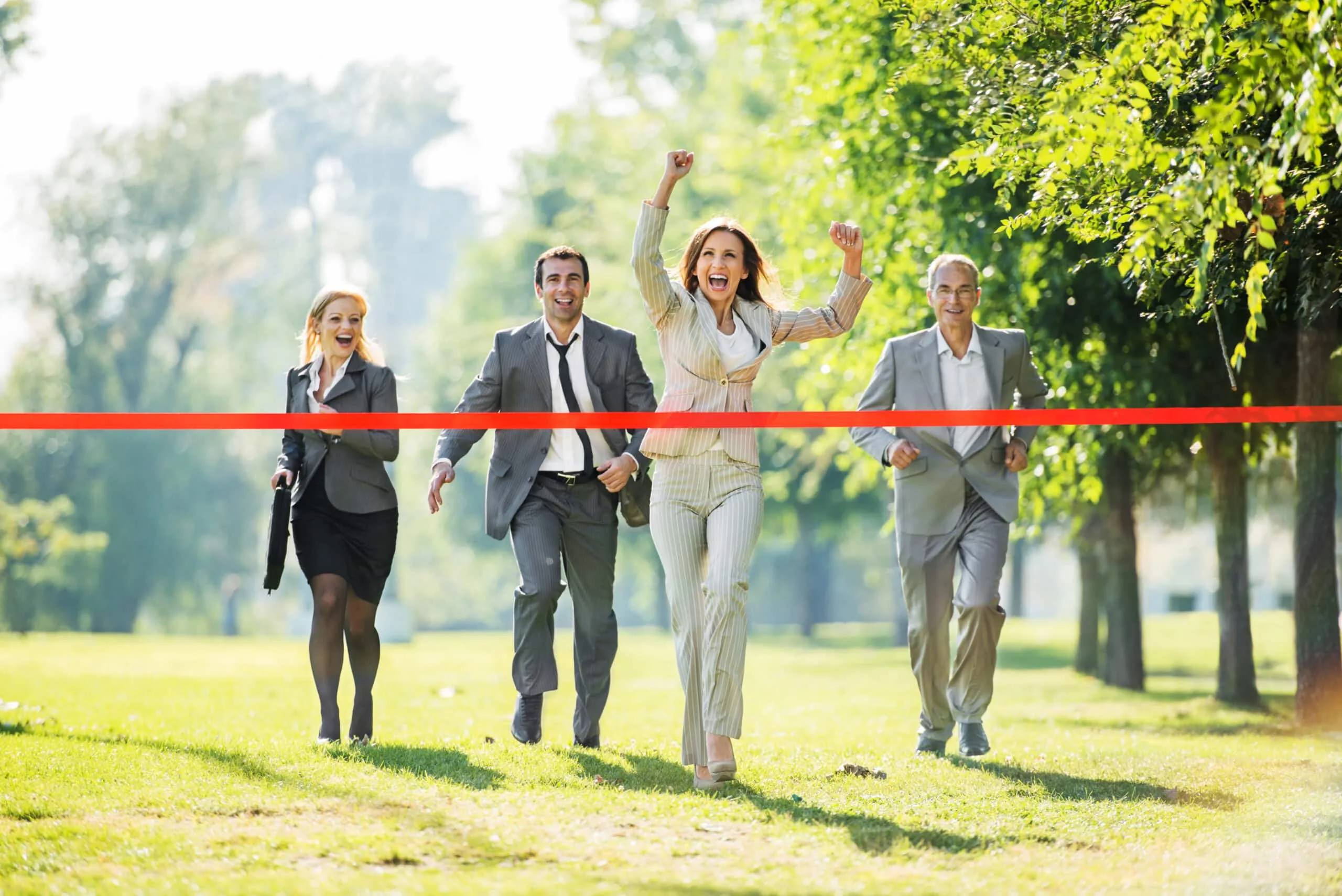 Business team celebrating as they cross a finish line